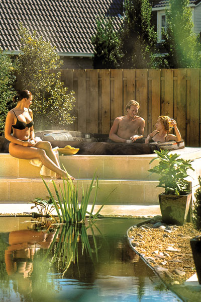 Coast Spas Curve Series spa design with family in hot tub